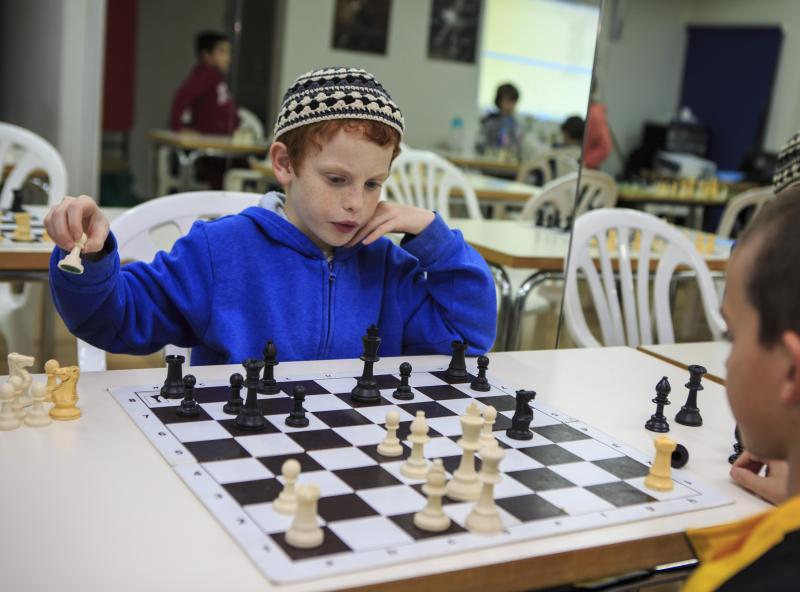 ילד מתחרה בשחמט מגבעת עדה